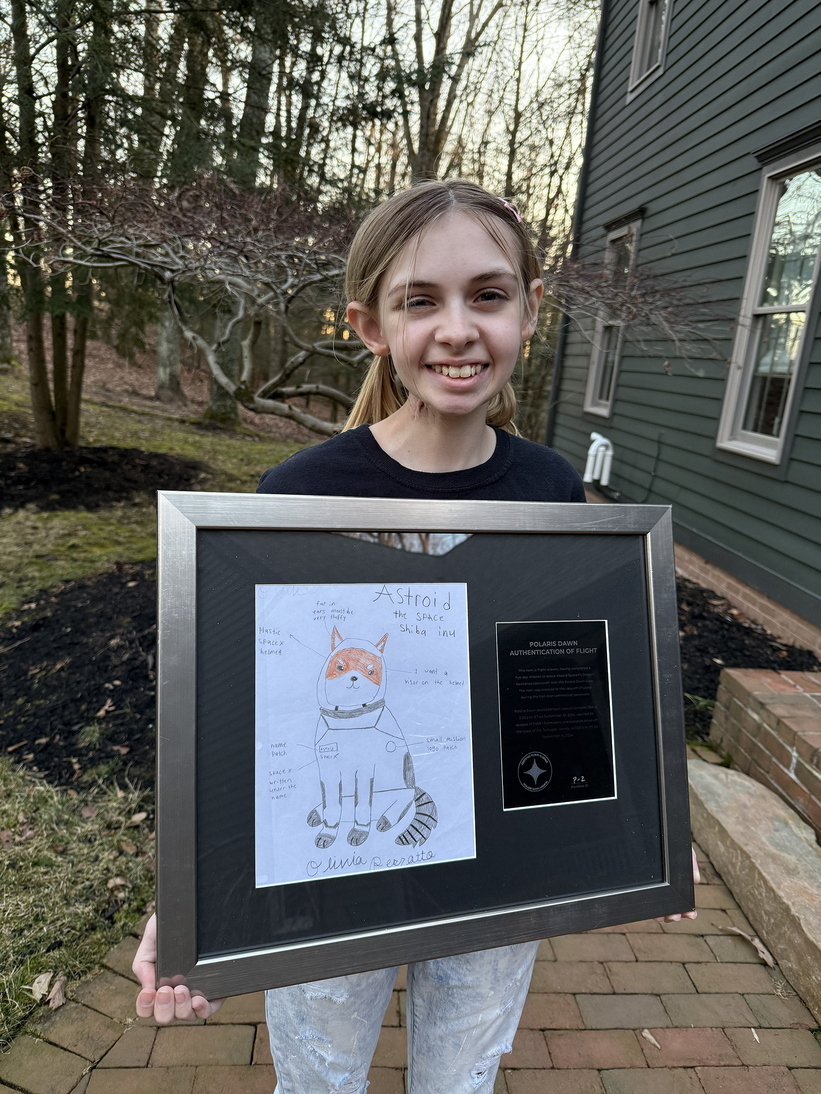 Olivia 'Liv' Perrotto holding her Asteroid drawing